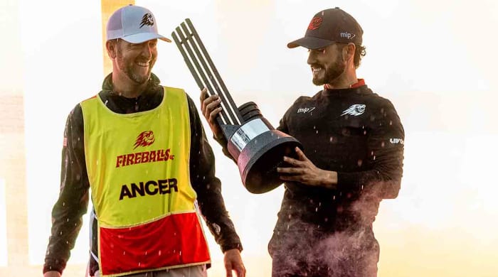 Abraham Ancer of Fireballs GC celebrates with his caddie, Benji Thompson, during the trophy ceremony after the final round of 2024 LIV Golf Hong Kong at the Hong Kong Golf Club.